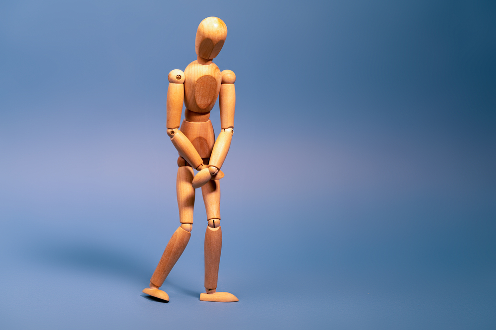 wooden figure holding bladder.