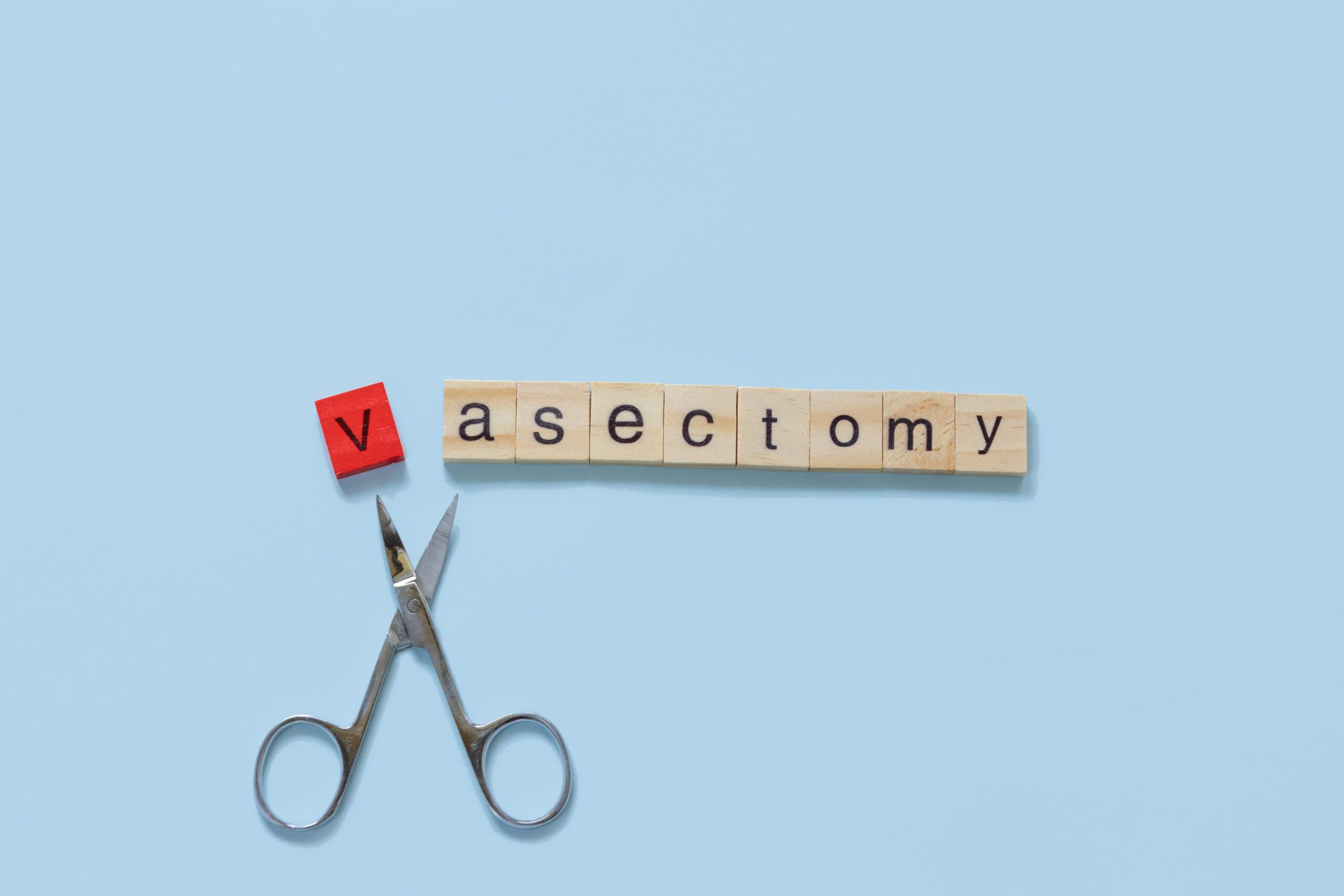 medical scissors with a sign with vasectomy.