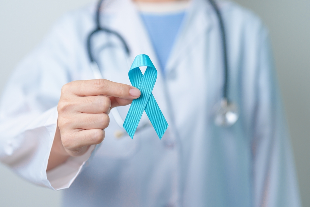 Doctor with Blue Ribbon in hospital for support people life and illness.