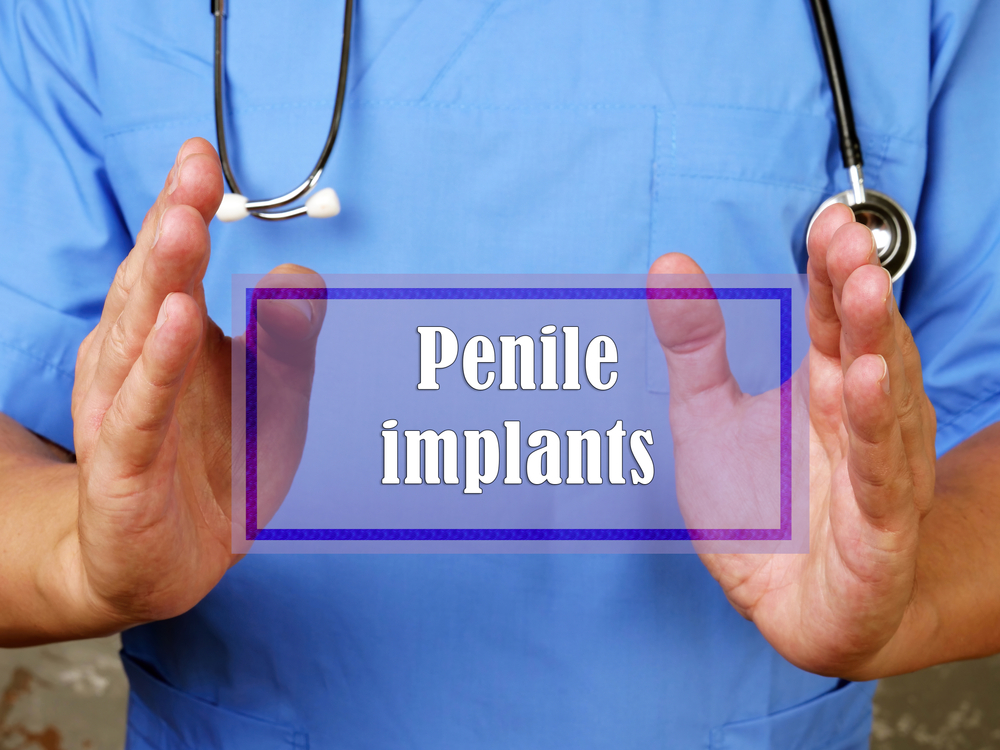 Doctor holding sign saying penile implants